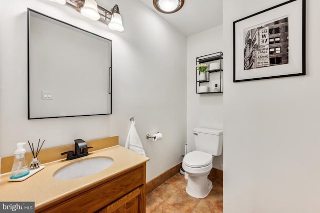 bathroom featuring tile patterned flooring, vanity, and toilet