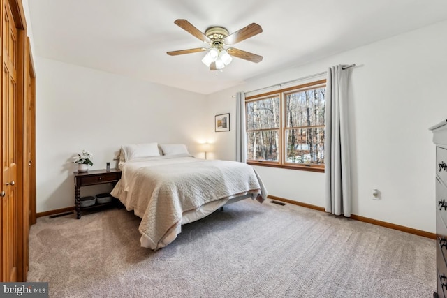 carpeted bedroom with a closet and ceiling fan