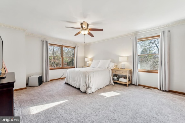 bedroom featuring ceiling fan, light colored carpet, and ornamental molding