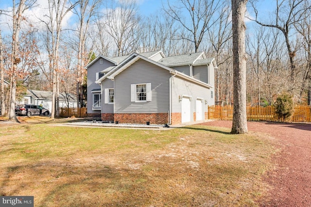 view of side of property with a garage and a lawn