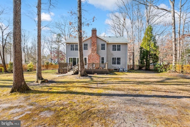 view of front of property featuring a front lawn and a wooden deck