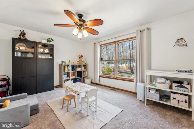 playroom with ceiling fan and carpet