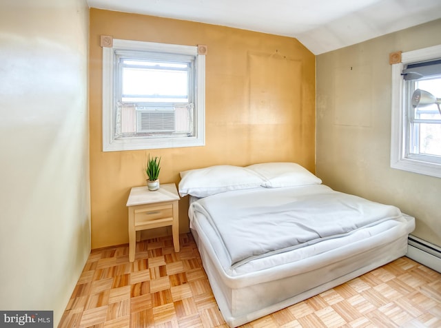 bedroom with cooling unit, a baseboard radiator, lofted ceiling, and light parquet floors