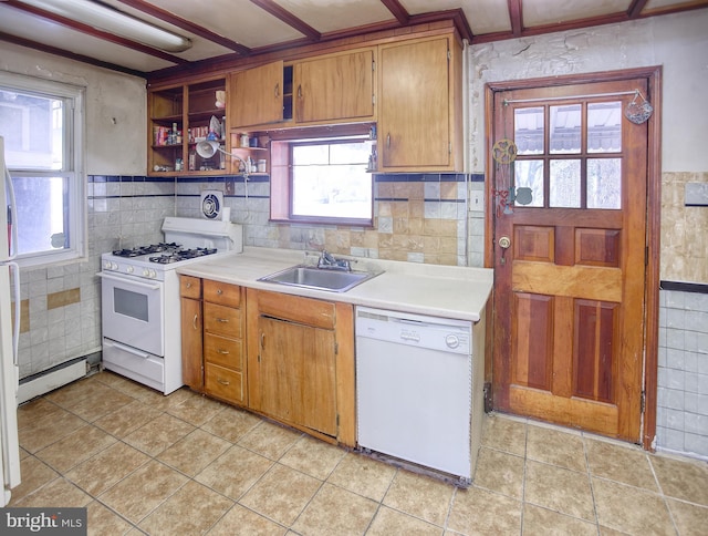 kitchen with a baseboard heating unit, sink, tile walls, and white appliances