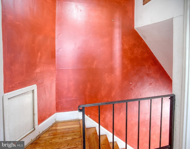 stairway with hardwood / wood-style floors