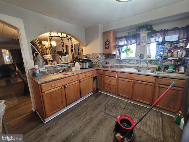 kitchen with sink, dark hardwood / wood-style flooring, and tasteful backsplash