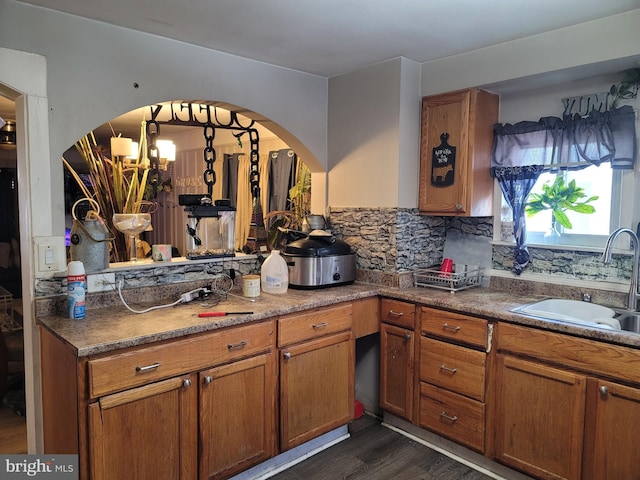 kitchen featuring sink, dark hardwood / wood-style flooring, and tasteful backsplash