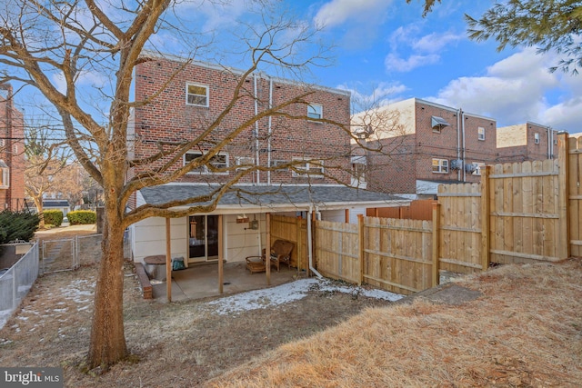 back of property with a patio