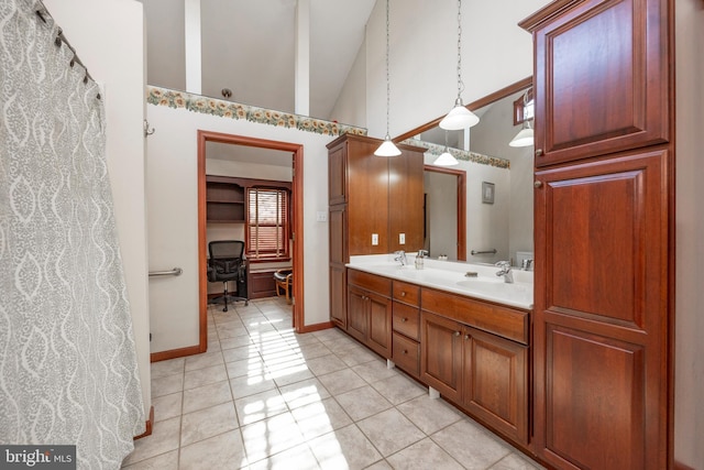 bathroom with tile patterned flooring, high vaulted ceiling, and vanity