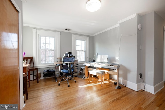 home office featuring ornamental molding and light hardwood / wood-style floors