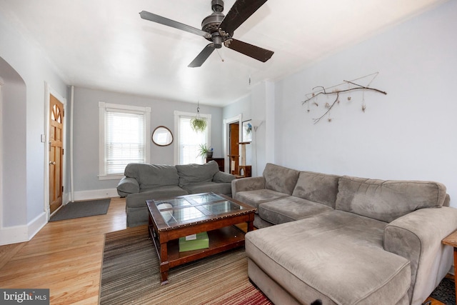 living room featuring ceiling fan and hardwood / wood-style floors