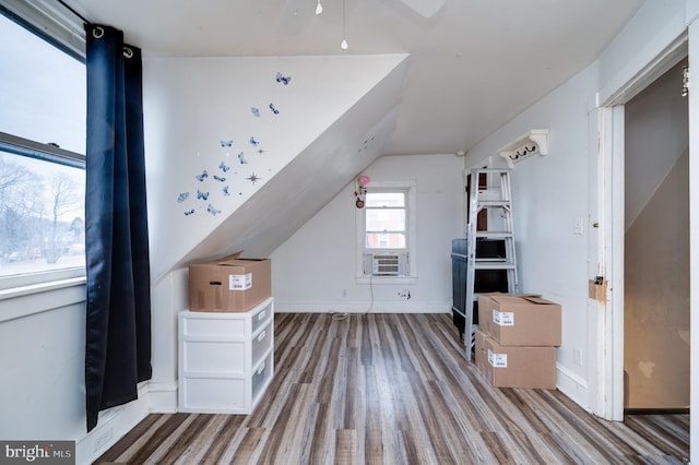 additional living space with lofted ceiling, hardwood / wood-style floors, and cooling unit