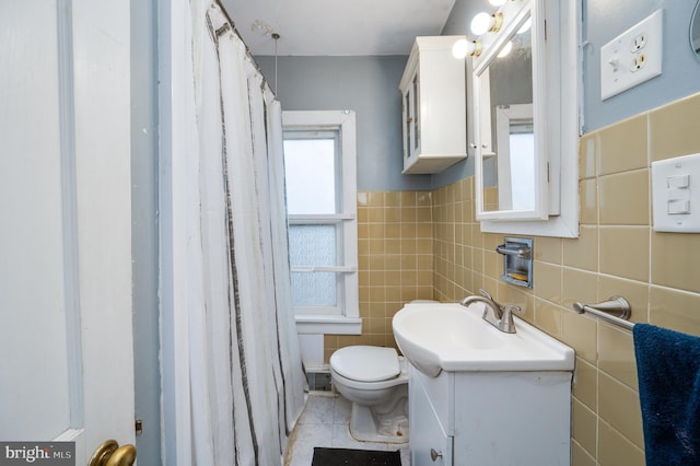 bathroom featuring vanity, tile patterned flooring, tile walls, and toilet