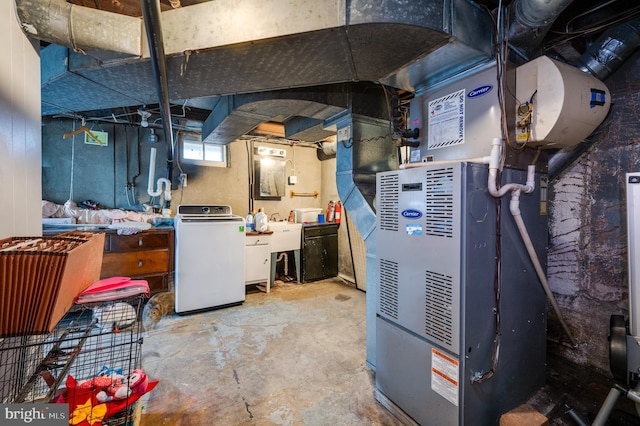 basement with heating unit, washer / clothes dryer, and sink