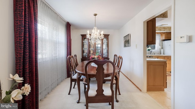 dining space with a wealth of natural light and a notable chandelier