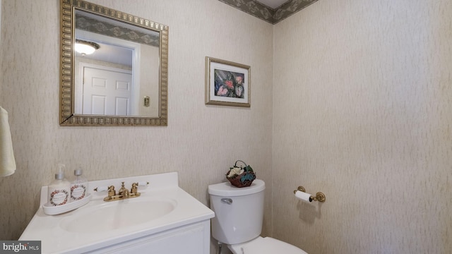 bathroom featuring toilet and vanity