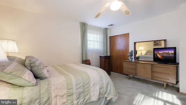 bedroom featuring ceiling fan and light colored carpet