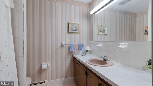 bathroom with toilet, vanity, baseboard heating, and a shower with curtain