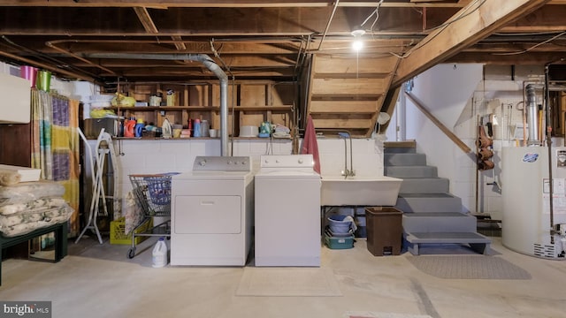 laundry area featuring water heater and independent washer and dryer