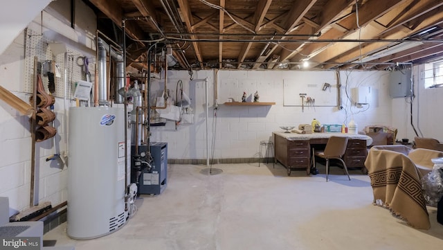 basement featuring electric panel, a workshop area, and gas water heater