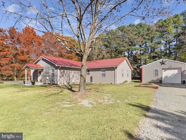 exterior space featuring a garage, an outdoor structure, and a front lawn