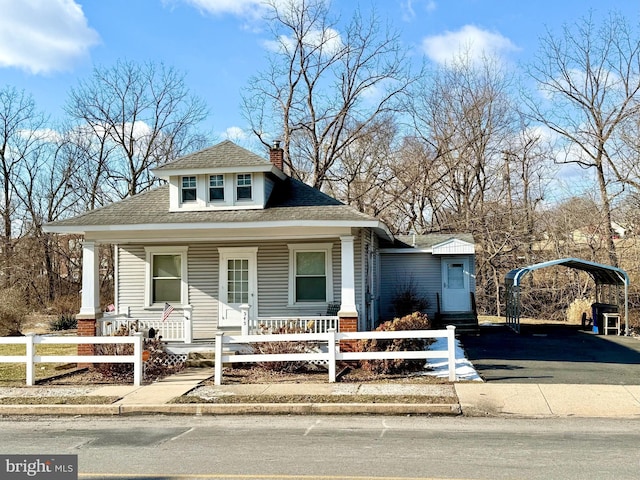 bungalow-style house with covered porch and a carport