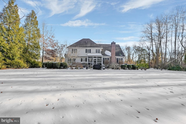 back of house featuring a sunroom