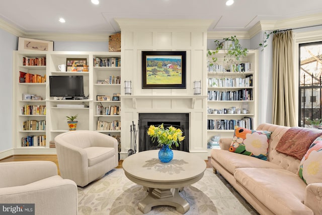 living area with light hardwood / wood-style flooring and crown molding