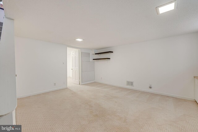 carpeted spare room with a textured ceiling