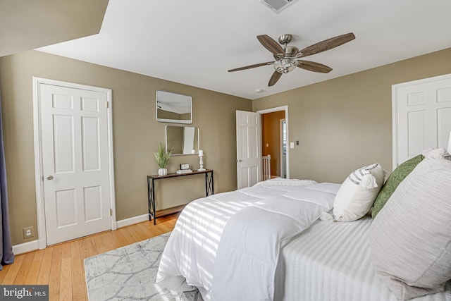 bedroom with ceiling fan and light hardwood / wood-style flooring