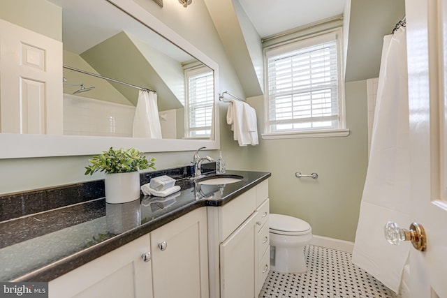 bathroom with toilet, vanity, and a shower with shower curtain