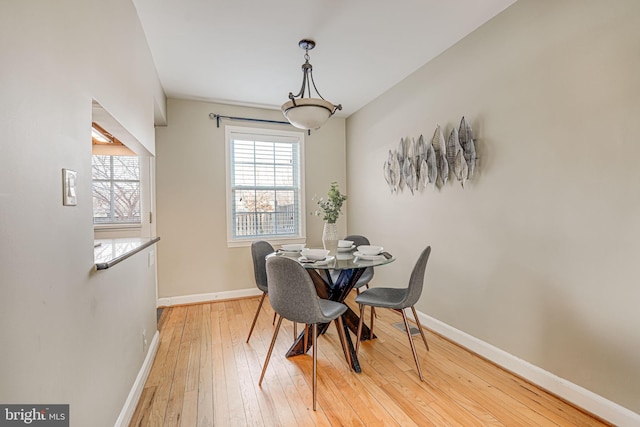 dining space with wood-type flooring