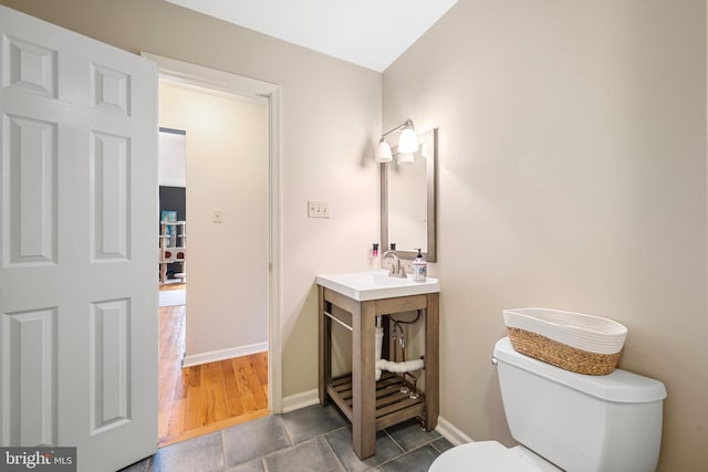 bathroom featuring tile patterned flooring, vanity, and toilet