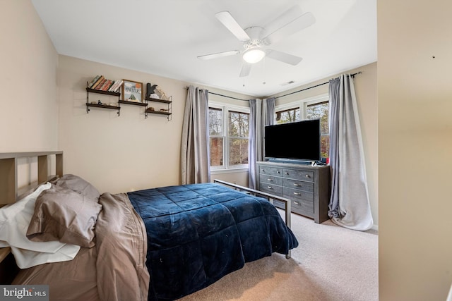 bedroom featuring light carpet and ceiling fan