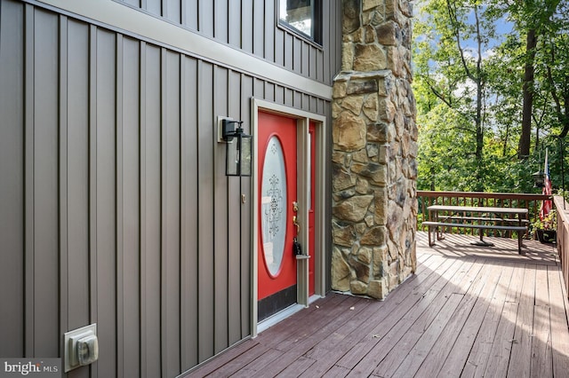 view of exterior entry with a wooden deck