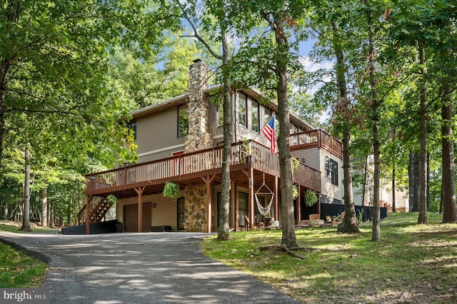 view of front of house featuring a deck and a garage