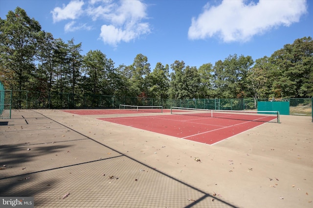 view of tennis court with basketball hoop