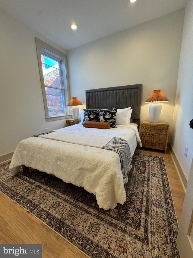 bedroom with hardwood / wood-style floors