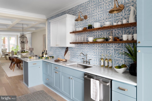 kitchen with stainless steel dishwasher, hanging light fixtures, white cabinets, coffered ceiling, and sink