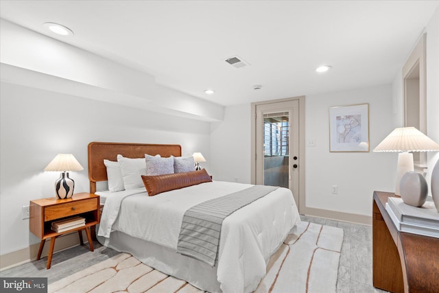 bedroom featuring access to exterior and light hardwood / wood-style flooring