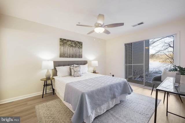 bedroom featuring hardwood / wood-style floors, access to exterior, and ceiling fan