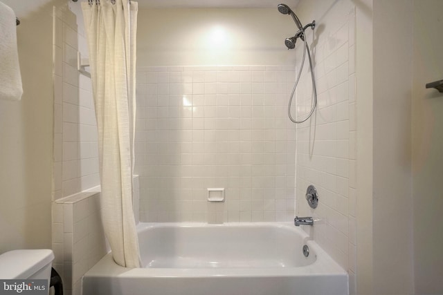 bathroom featuring toilet and shower / bath combo with shower curtain