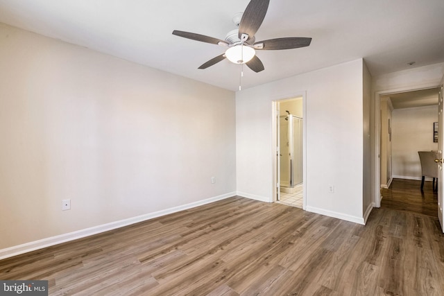 spare room with hardwood / wood-style flooring and ceiling fan