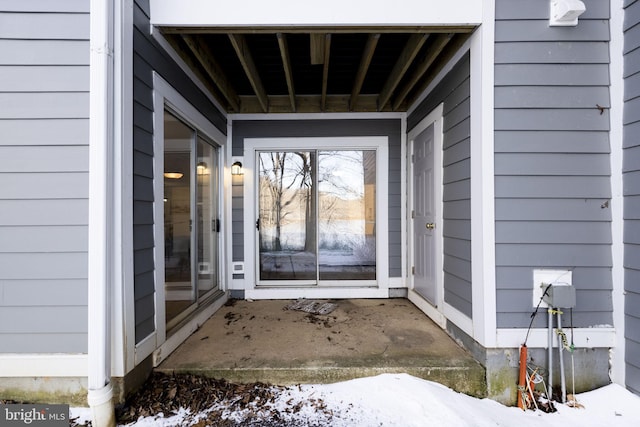 view of snow covered property entrance