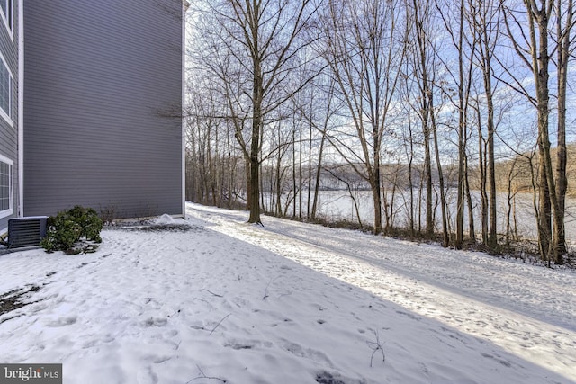 yard covered in snow featuring cooling unit