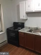 kitchen featuring sink, white cabinetry, electric range, and dark wood-type flooring