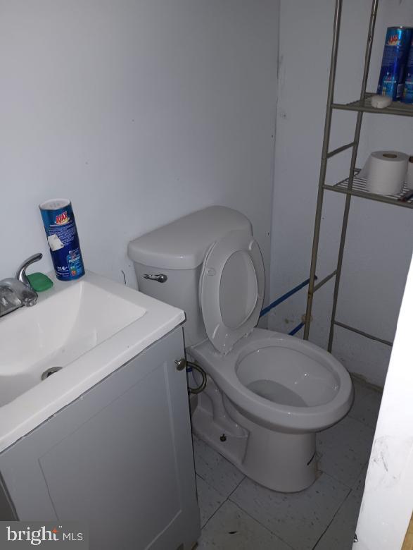 bathroom with vanity, tile patterned floors, and toilet