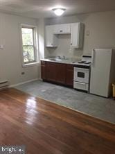 kitchen featuring white appliances, light hardwood / wood-style flooring, white cabinets, and sink