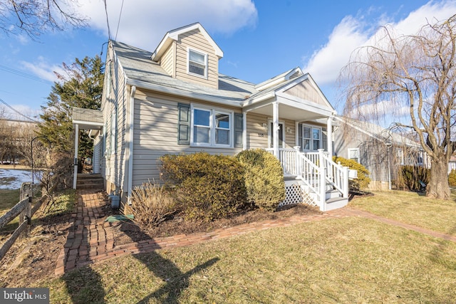 view of front of house with a front yard and covered porch