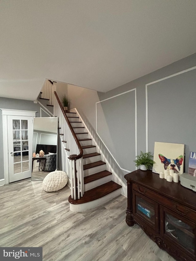 staircase featuring wood finished floors